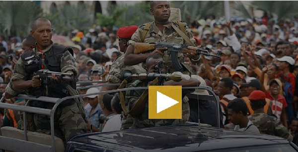 Rebel soldiers lead the convoy bringing opposition leader Andry Rajoelina to a rally in Antananarivo