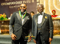 Prophet Uche (L) was presented with a commemorative gold coin by Otumfuo (R)