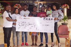 Victoria Michaels (R) poses with her team and beneficiaries of her donation