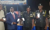Dr Mahamudu Bawumia (2nd from the left), Ambrose Dery (2nd from the left) displaying the devices
