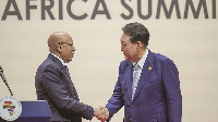 South Korean President Yoon Suk Yeol (right) shakes hands with Mohamed Ould Ghazouani