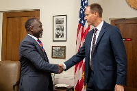 Dr Ayine (L) with a top official of the US Department of Justice
