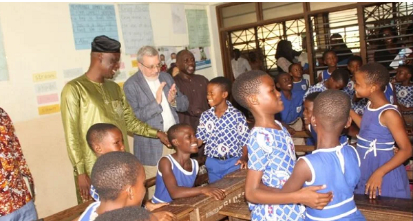 Haruna Iddrisu (left) and Robert Taliercio interacting with pupils of Osu St. Thomas Presby Primary