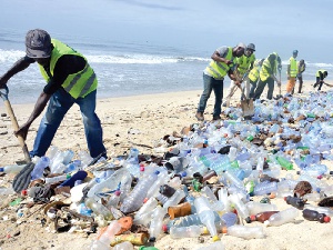 Some cleaners clearing up plastic waste at the beach