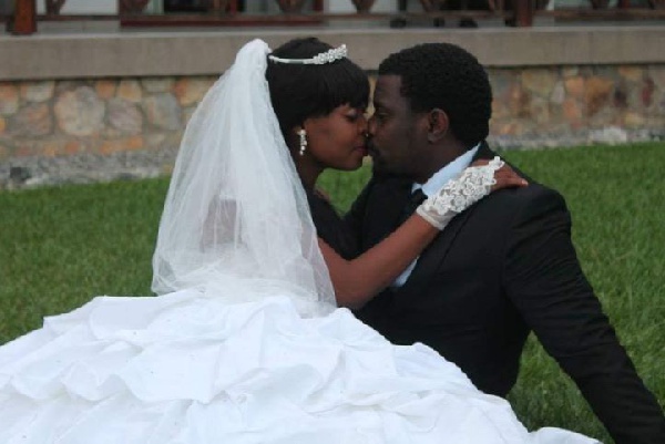 Dzidzor Mensah and John Dumelo sharing a kiss