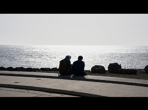 Two young men sitting on a beach in Dakar, Senegal Two young men sitting on a beach in Dakar, Senegal