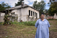 Ward 104 councillor Emi Koekemoer next to a government-owned property, which was hijacked