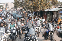 NDC supporters in green army wing on motorbikes riding through Nima in Accra