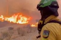 An emergency worker looks on during a wildfire in Almeria, Spain