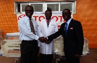 Peter Asante (right) presenting the beds to KATH officials