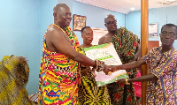 Nana Kweku Esieni V, the Regent of Agona Swedru presenting a citation to an awardee