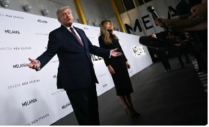 Donald Trump and F Melania Trump speak to journalists as they attend her world premiere