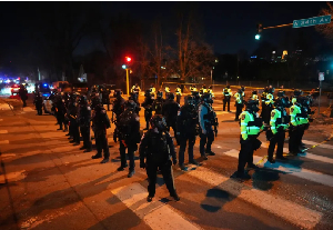 Law enforcement officers stand after a shooting in Minneapolis, on Wednesday Law enforcement officers stand after a shooting in Minneapolis, on Wednesday