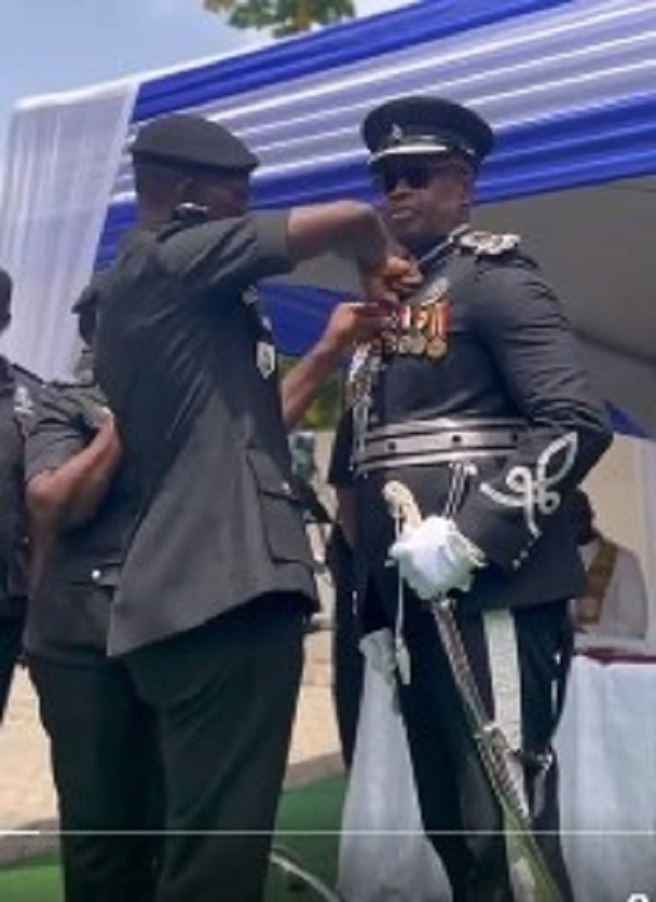 COP Nathan Kofi Boakye (right) being decorated by IGP George Akuffo Dampare at his retirement party
