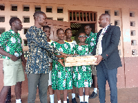 Engineer Eric T. Ayertey (L) presented laptops to the Mt. Mary Demonstration JHS during his visit.