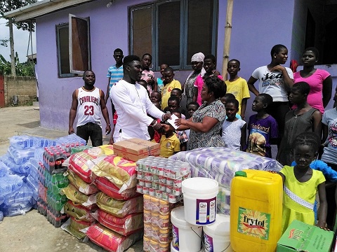 Daniel Martey Laryea handing over the items