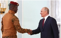 Burkina Faso's President Ibrahim Traore (L) greets Russian President Vladimir Putin