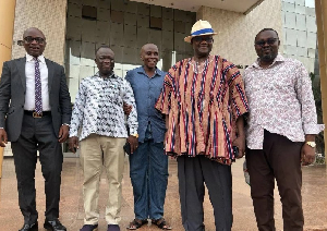 Gregory Afoko [Middle] with his family members after his release