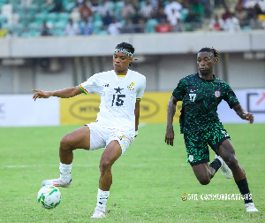 Nations FC defender Razak Simpson  (controlling the ball )