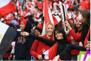 Egyptian fans cheer their side on at stadium.