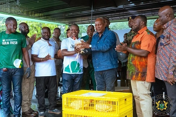 President Mahama (third from right) being presented with a fowl during his visit to the farm