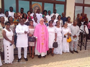 Doctors from Family Health Medical School in a group picture with Rev. Father Andrew Campbell