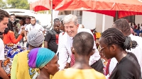Elder Nielsen exchange pleasantries with some of the beneficiaries