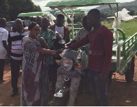 Linda Akweley Ocloo, (MP) for Shai-Osudoku Constituency presenting tricycle to some constituents