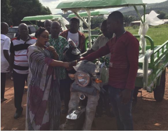 Linda Akweley Ocloo, (MP) for Shai-Osudoku Constituency presenting tricycle to some constituents