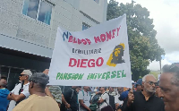 Lalit-affiliated activists hold a banner calling for the closure of the Diego Garcia military base