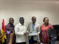 A photo of the Transport Minister, Kwaku Ofori Asiamah receiving the report from Ing Ayeh