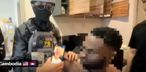 Screenshot from video on arrest of suspected romance scammers