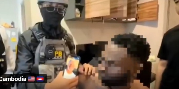 Screenshot from video on arrest of suspected romance scammers
