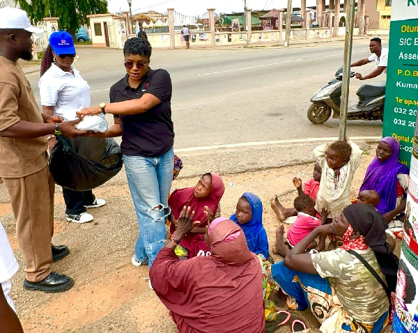 Diana (in black T-shirt) handing over some things to some of the people on the streets