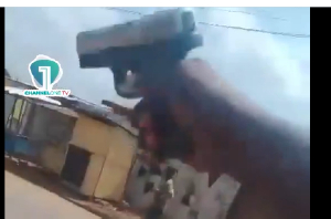 This snipped video image shows an armed man firing at targeted individuals