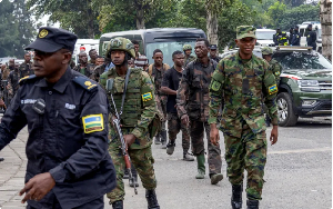 Rwandan security officers escort members of the armed forces of the DRC