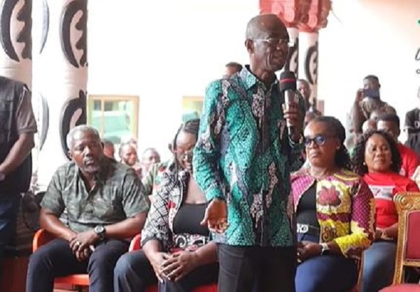 Johnson Asiedu Nketia (with microphone) narrates the incident to the chief of Akwatia