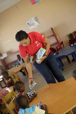 Hannah Agbozo, Legal & Corporate Affairs Director distributing  drinks to the kids