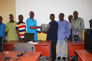 1986 year group of Obuasi Secondary Technical giving laptops to the school's leadership
