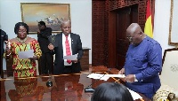 President Akufo-Addo swearing in two members of the Board of PURC