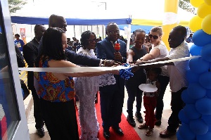 Mrs. Adelaide Siaw Agyepong, CEO of the school with others cutting the ribbon to inaugurate the sch.