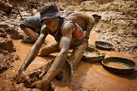File Photo : A man working in a mining pit