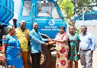 Mr Ocran (M) presenting the keys to the trucks to Mrs Adwoa Amoako (3rd right), MCE for Tema West