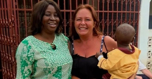 Tracey Dennison with a child and their teacher at Living World of Faith World Changers in The Gambia Tracey Dennison with a child and their teacher at Living World of Faith World Changers in The Gambia