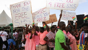 Students brandishing placards in praise of Free SHS