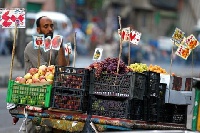 A trader selling fruits on a street