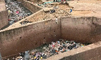 Photo of a gutter filled with filth
