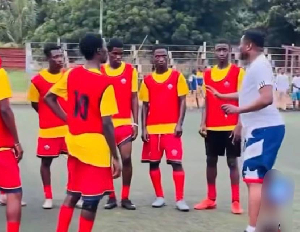 Gyan (in white) talking to his players