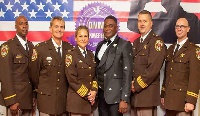 Bishop Adonteng with US police at the Faithful Servants Awards