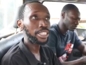 Jesse Samuel (in black polo shirt) arrested by residents over MoMo theft.
